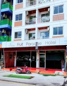 a scooter parked in front of a hotel at Fruit Paradise in Patong Beach