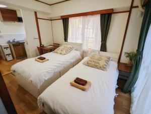 two beds in a room with two towels on them at Amber Iidabashi - Vacation STAY 89899v in Tokyo