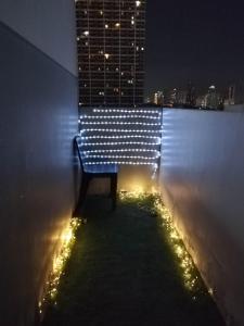 a bench sitting on the side of a building at night at SMDC Breeze Residences in Manila
