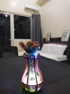 a colorful vase with flowers in it on a table at SMDC Breeze Residences in Manila