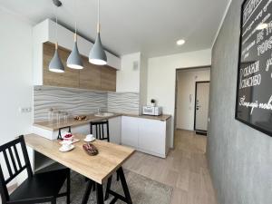 cocina y comedor con mesa de madera en Элитная квартира в центре, en Pavlodar