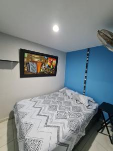 a bedroom with a bed and a tv on the wall at Apartamentos Vistas del Caribe in Cartagena de Indias