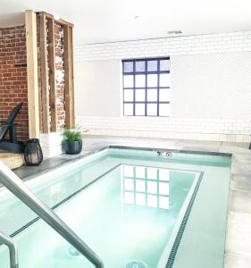 a swimming pool in a room with a brick wall at Family Laundry & Spa in Sacramento