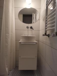 a bathroom with a sink and a mirror at Peaceful Home in Thessaloniki