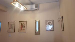 a wall with four pictures and a mirror on it at Botanical house in San Miguel de Tucumán