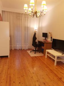 a living room with a desk and a computer at Peaceful Home in Thessaloniki