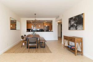 a kitchen and dining room with a table and a dining room at Modern Oceanview Condo - Steps to the Beach! in Miami Beach