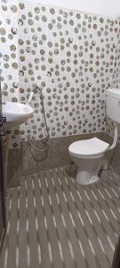 a bathroom with a toilet and a sink at OYO Raj Villas in Satna