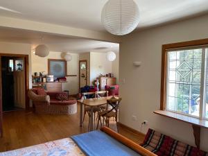 a living room with a table and a dining room at Joya Garden & Villa Studios in Nelson