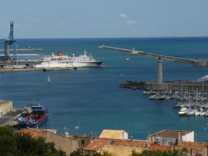 a cruise ship is docked in a harbor at Paris-Sète T2 au coeur de Sète in Sète