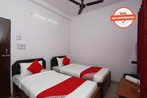 two beds in a room with a sign that reads no remembered at Collection O Aditya Inn in Jamshedpur