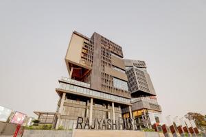um edifício alto com um sinal em Townhouse Rajyash Rise em Sarkhej