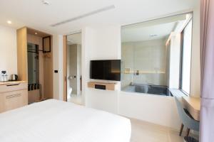 a bedroom with a bed and a large mirror at Hsing Fu Hot Spring Hotel in Jiaoxi