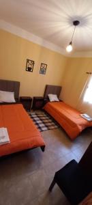 a bedroom with two beds in a room at Departamentos Tilcara in Tilcara