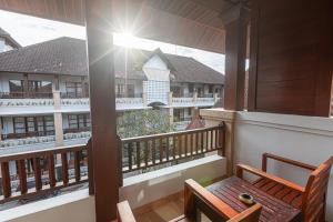 a balcony with two benches and a view of a building at Fourteen Roses Beach Hotel in Legian