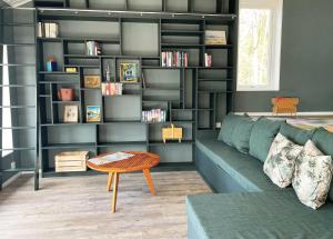 a living room with a couch and a book shelf at Fantastic holiday home with own lake plot by Bolmen, Ljungby in Ljungby
