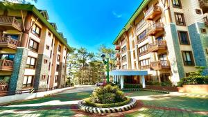 a large building with a courtyard in front of it at BRENT RESIDENCES BAGUIO in Baguio