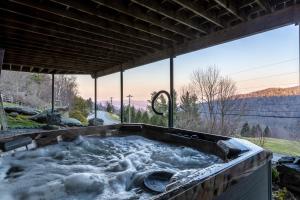 a jacuzzi tub with a view of the mountains at Eagles Nest on Seven Devils in Seven Devils