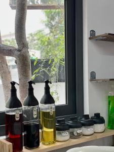 a shelf with bottles on it with a window at TM Hometay Trung Tâm Phan Thiết in Phan Thiet