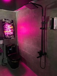 a bathroom with a shower with a pink light at TM Hometay Trung Tâm Phan Thiết in Phan Thiet