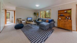 a living room with a couch and a tv at Florida Trees Free Wifi Surf Side in Inverloch