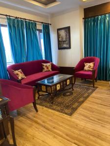 a living room with two couches and a coffee table at Summer House in Mussoorie