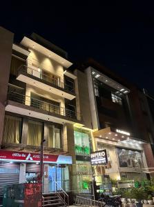 a building at night with a sign in front of it at Hotel The Imperio in New Delhi