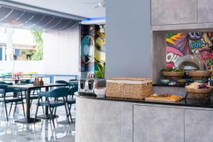 a restaurant with a counter with food on it at Akira Pattaya in Jomtien Beach