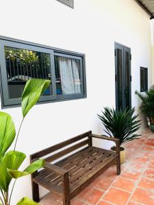 a wooden bench sitting in front of a building at TM Hometay Trung Tâm Phan Thiết in Phan Thiet