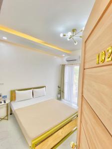 a bedroom with a bed and a wooden door at The Mansion - Olongapo in Olongapo