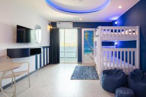 a childs room with a crib and a table and chairs at Akira Pattaya in Jomtien Beach