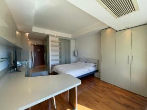 um quarto com uma cama e uma secretária. em Beijing Elegant Seasons Park Apartment em Pequim