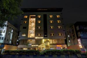 a hotel building with lights on at night at Super Townhouse OAK Regal Inn Near Sant Tukaram Nagar Metro Station in Chinchiwad