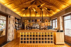 a bar in a restaurant with a wooden ceiling at Kentrikon Hotel in Lagkadia