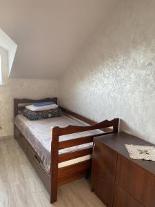 a small bedroom with a bed and a dresser at A&K Retreat Center in Prilbichi