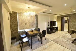 a living room with a dining room table and chairs at Sarkar Chambers in Mumbai