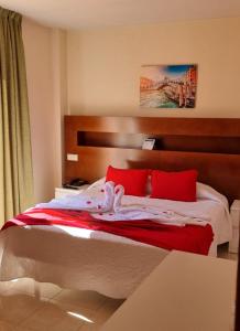 A bed or beds in a room at Hostal San Marcos