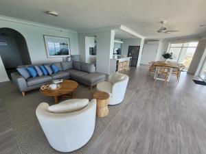a living room with a couch and a table at Burleigh Surf Apartments in Gold Coast