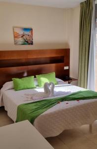 A bed or beds in a room at Hostal San Marcos