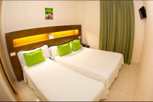 A bed or beds in a room at Hostal San Marcos