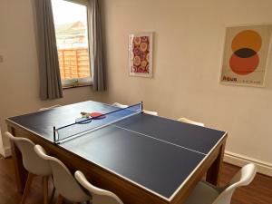 a ping pong table in a room with chairs at Large 3 bed - Pool Table - Xbox - Netflix in Lincolnshire