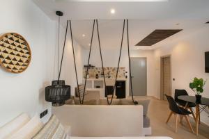 a living room with a white couch and a table at Naxos Village hotel in Naxos Chora