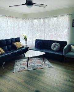 a living room with a couch and a coffee table at Cozy House With Great Backyard in Frazier Park