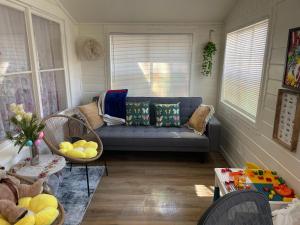 a living room with a couch and a table at Cozy House With Great Backyard in Frazier Park