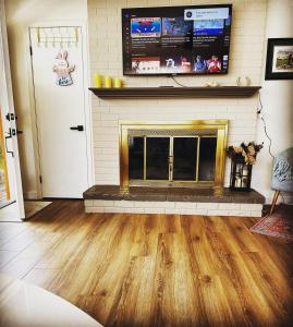 a living room with a fireplace and a tv at Cozy House With Great Backyard in Frazier Park