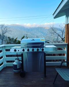 a grill on a porch with a view of the mountains at Cozy House With Great Backyard in Frazier Park