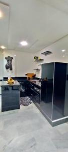 a kitchen with black and white appliances in a room at Serenehouse in Marrakesh