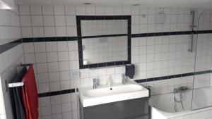 a bathroom with a sink and a mirror and a tub at Rembrandt Square Boat in Amsterdam