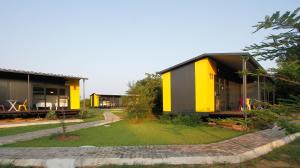 a house with a yellow and black facade at SleepOver Phabeni in Hazyview