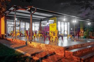 a group of yellow tables and chairs on a patio at SleepOver Phabeni in Hazyview